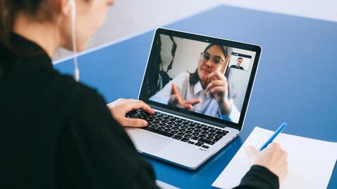 A person using a laptop on a video conference