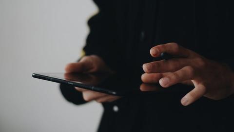 a person holding and using a digital tablet