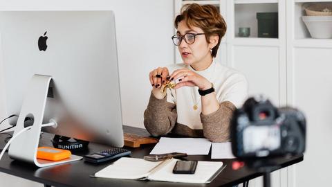 A woman sitting at her desk in front of a computer