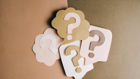 Paper cutouts of question marks