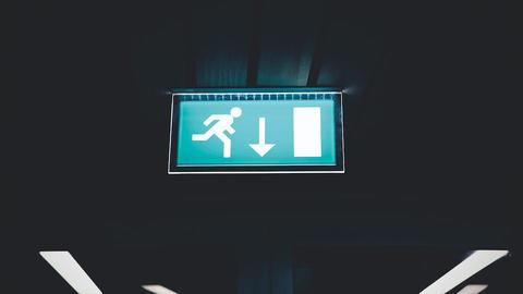 a ceiling-mounted green emergency exit sign