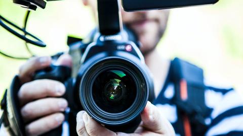 A video camera lens pointed towards the viewer