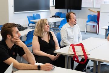 Students sit and listen during a classroom discussion.