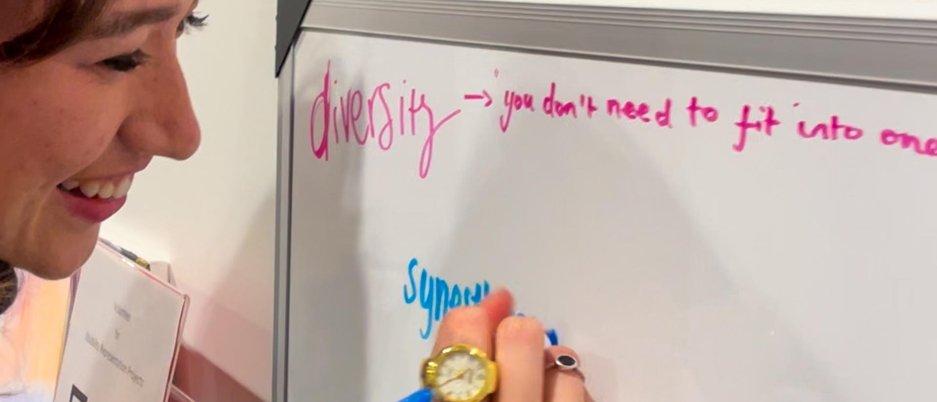 A woman writes on a whiteboard